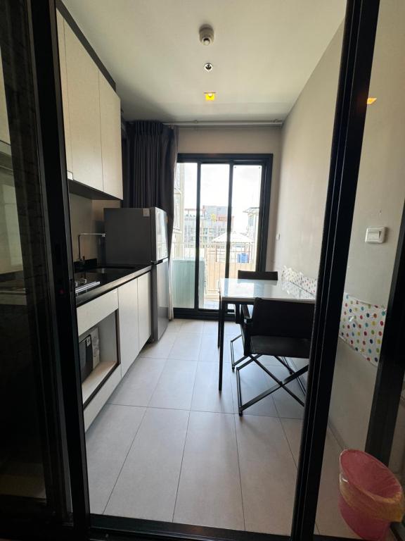 a kitchen with a table and a dining room at 芭提雅市中心The Base 高端公寓酒店 in Pattaya