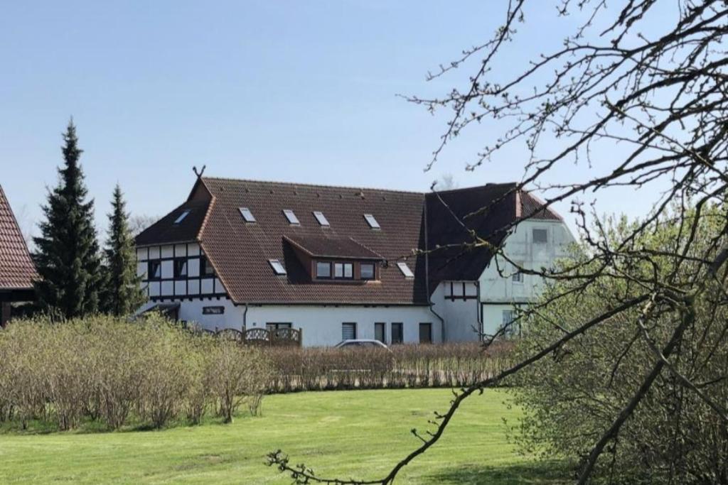 a large white house with a brown roof at Fewo 71 Kleine 1 Raumwohnung in Roggow in Roggow
