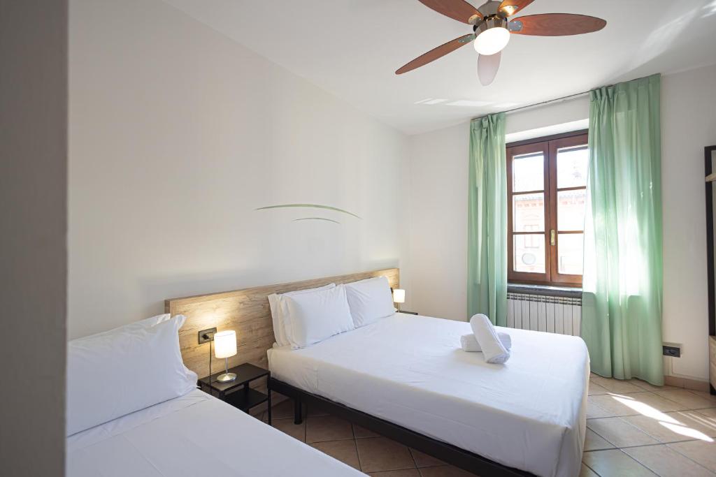 Postel nebo postele na pokoji v ubytování Hotel Tornielli 9 by LVG Hotel Collection