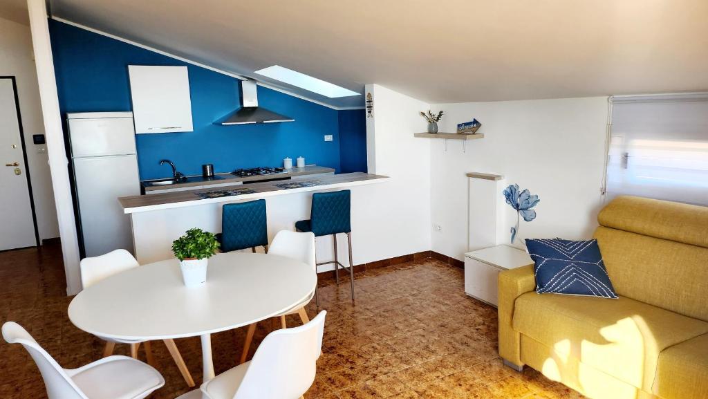 a kitchen and living room with a table and a couch at Rio Vivo Home in Termoli