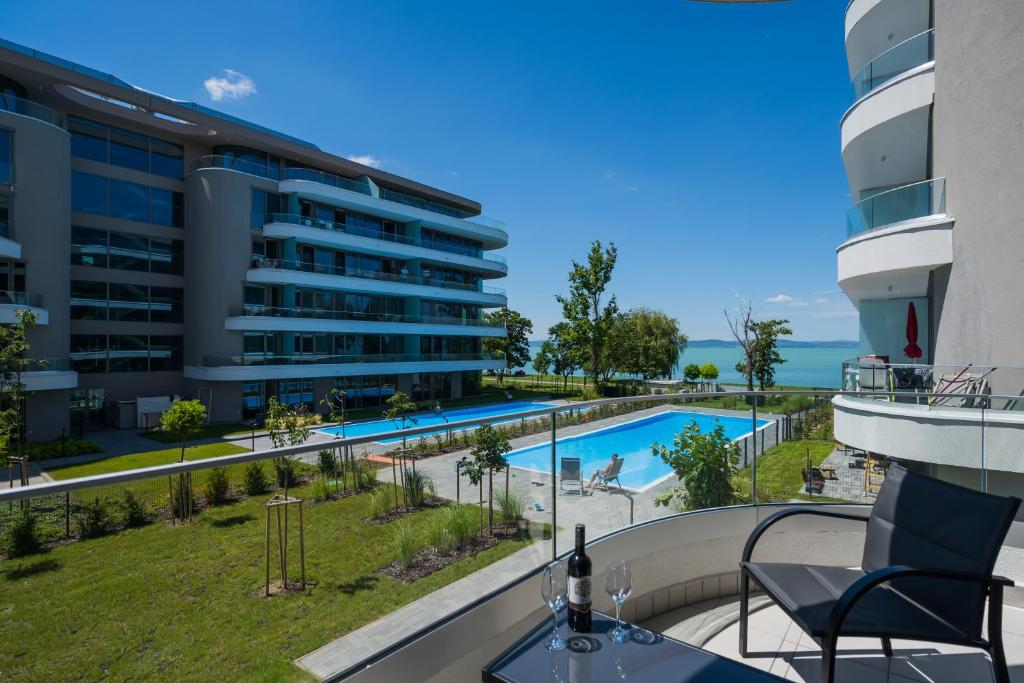 a view of the pool from the balcony of a building at MyFlat Wave Yacht Apartment in Siófok