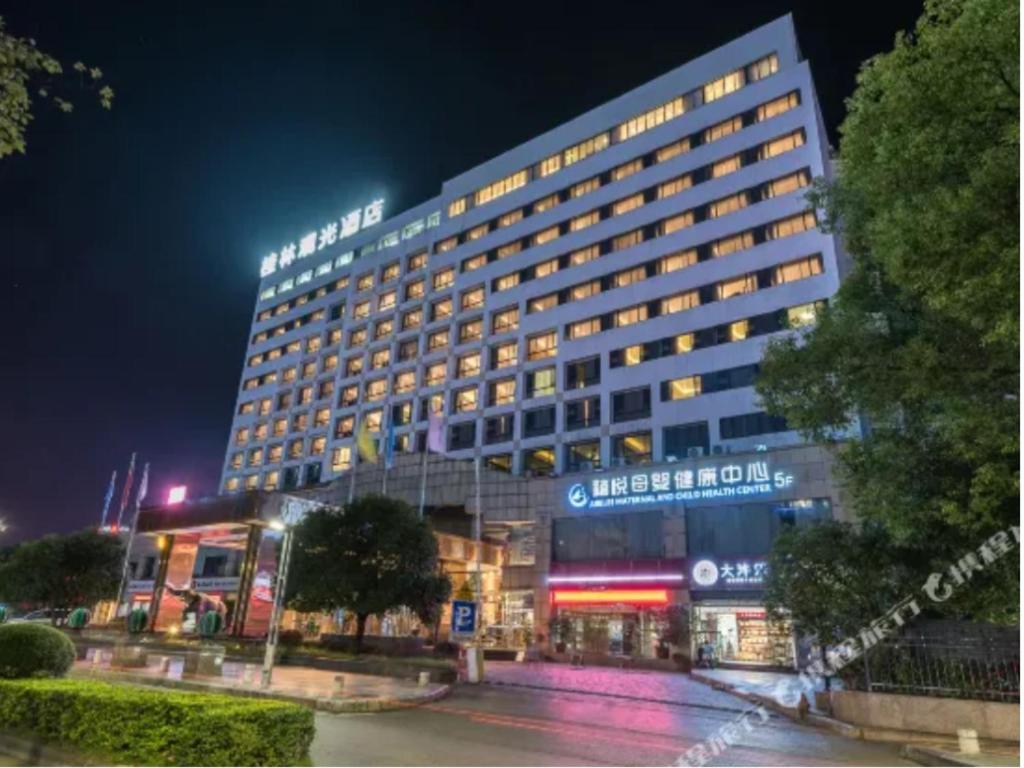 a lit up hotel building at night at Guilin Plaza Hotel in Guilin