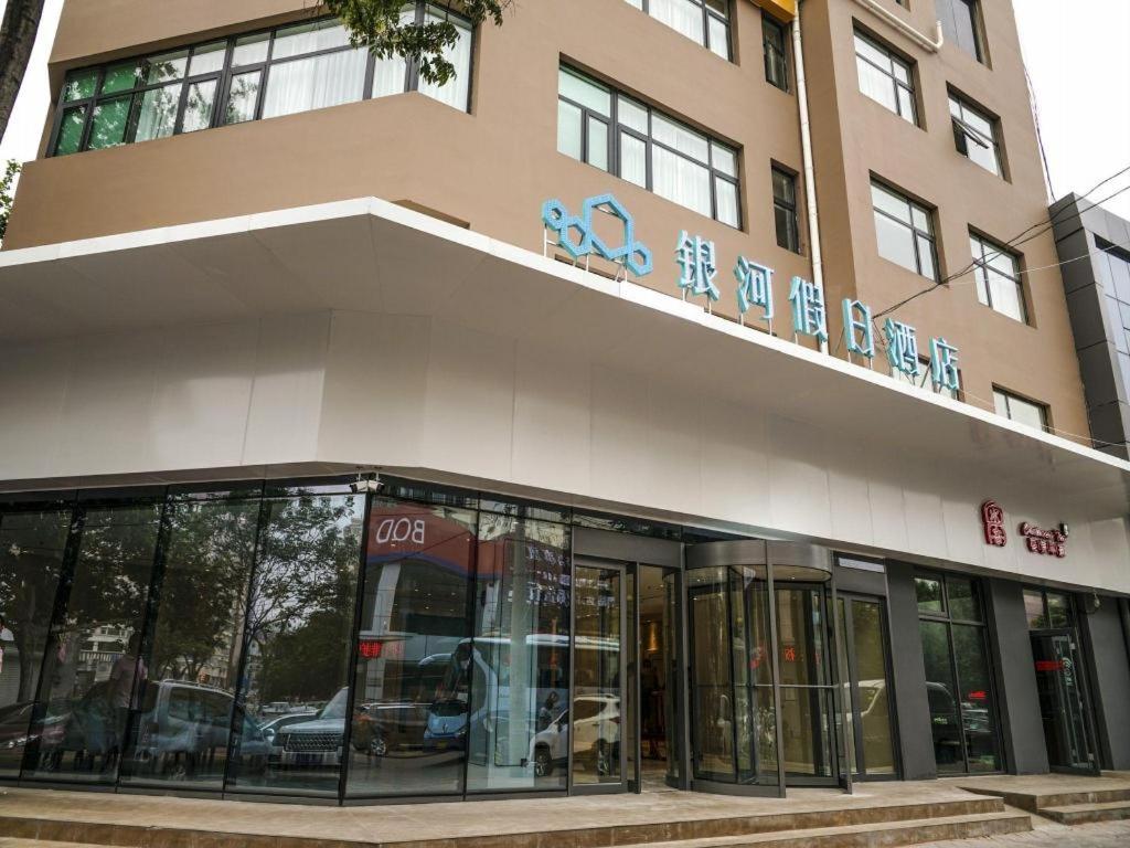 青島市にあるQingdao Galaxy Holiday Hotelのガラスのドアが付いた建物の店先