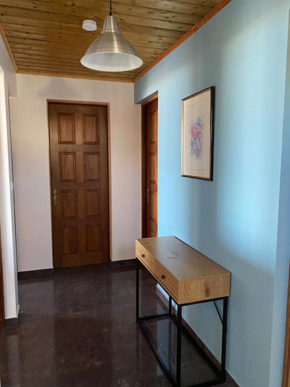 a room with a wooden table and a door at Location saisonnière A portée de vue in La Possession
