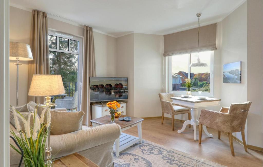a living room with a couch and a table at Baltischer Hof Apartment 27 in Boltenhagen