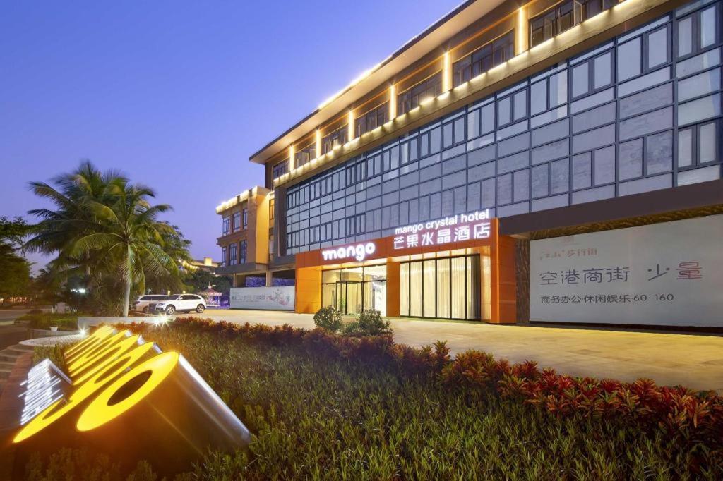 a building with a bench in front of it at mango crystal hotel in Haikou