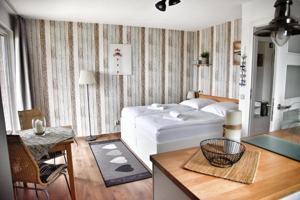 a bedroom with a bed and a desk and a table at Lagunenstadt am Haff Fewo 166 - Nautilus in Ueckermünde