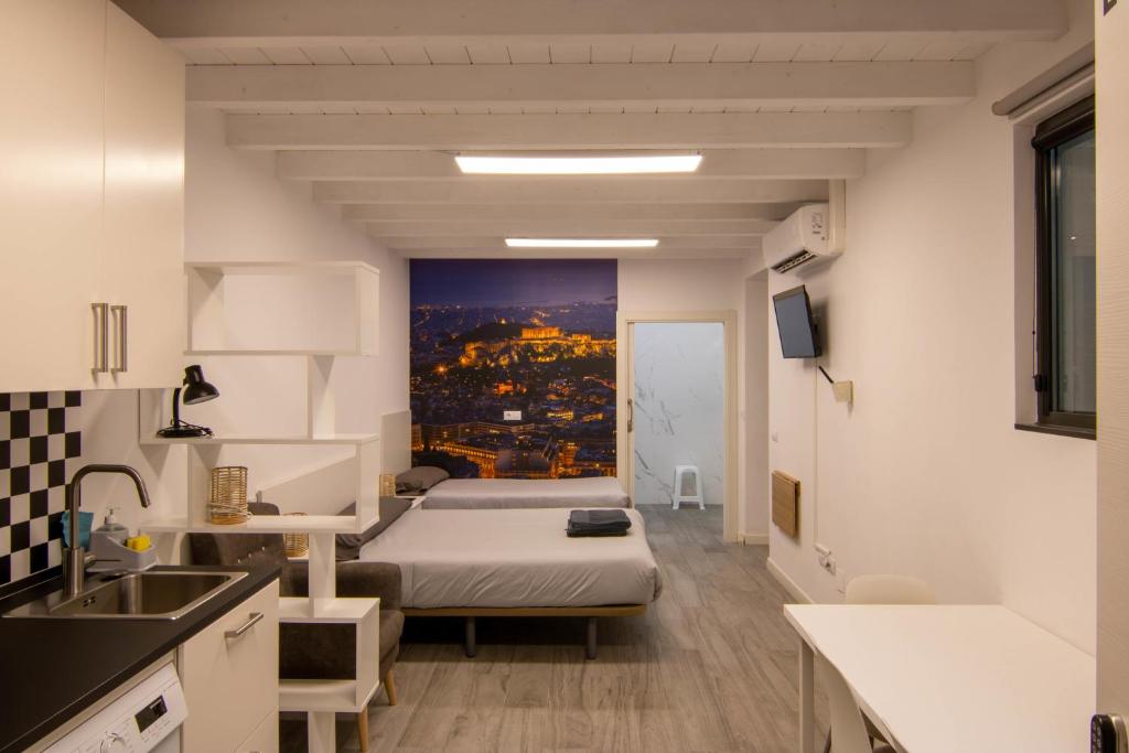 a small room with a bed and a view of a city at Loft atenas in León
