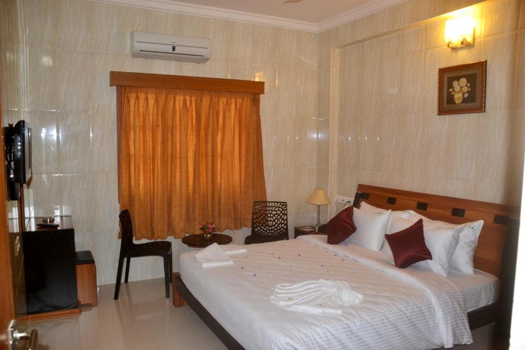 Postel nebo postele na pokoji v ubytování Peace Inn Chennai