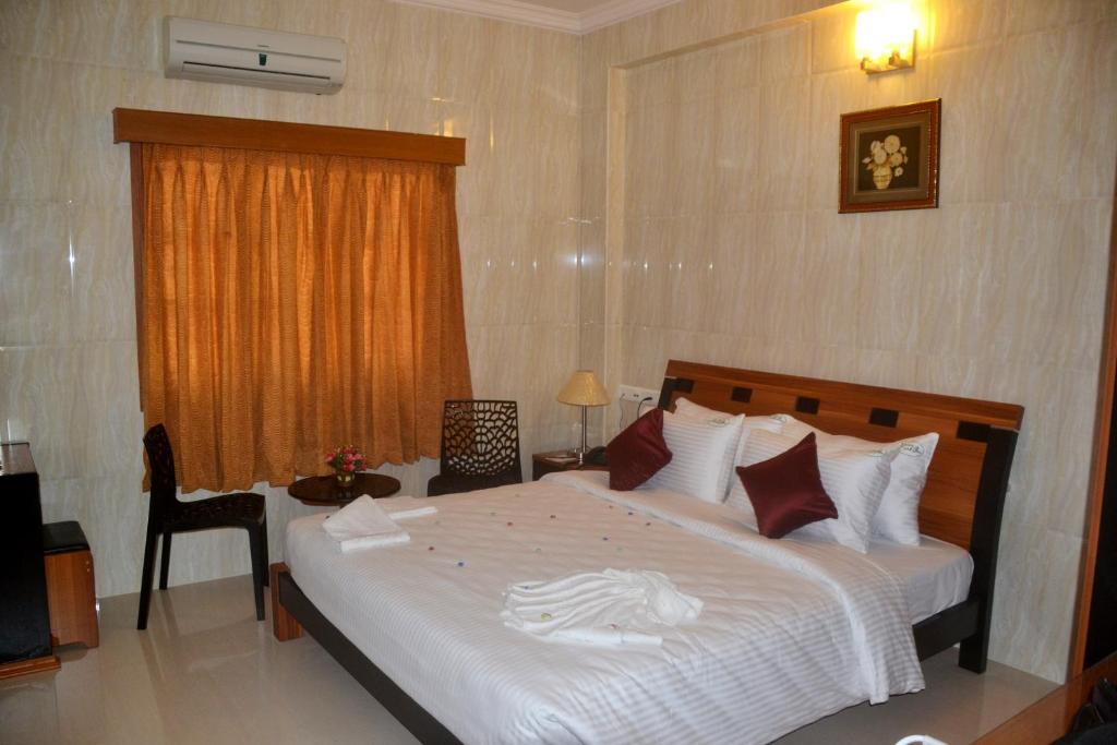 Postel nebo postele na pokoji v ubytování Peace Inn Chennai