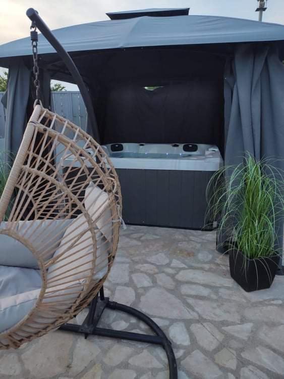 a swinging chair sitting under a table with a tub at Villa Marko 3 Bedrooms apartment in Pula