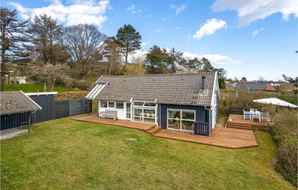 a house with a large yard with a deck at Holiday Home Lyngsbækvej Ix in Ebeltoft
