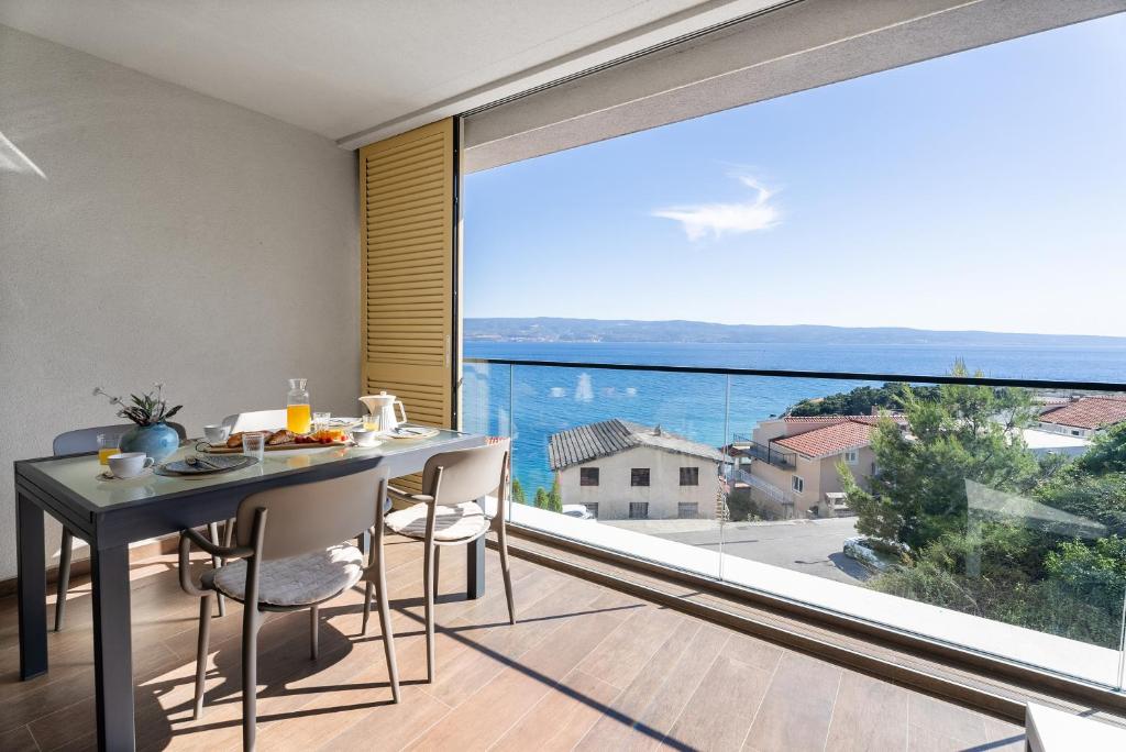 a dining room with a table and a large window at Apartment Concha in Dugi Rat