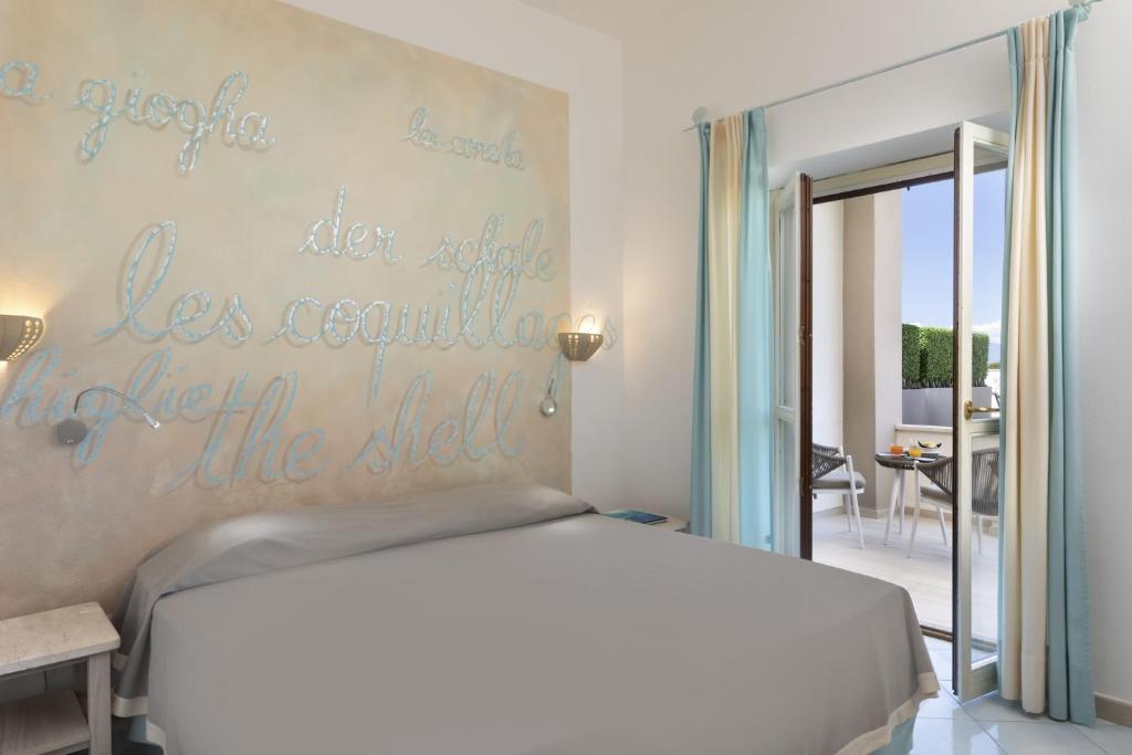 Postel nebo postele na pokoji v ubytování Hotel Corallaro