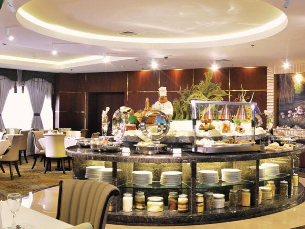 a buffet line with food on a table in a restaurant at Dalian Liangyun Hotel in Dalian