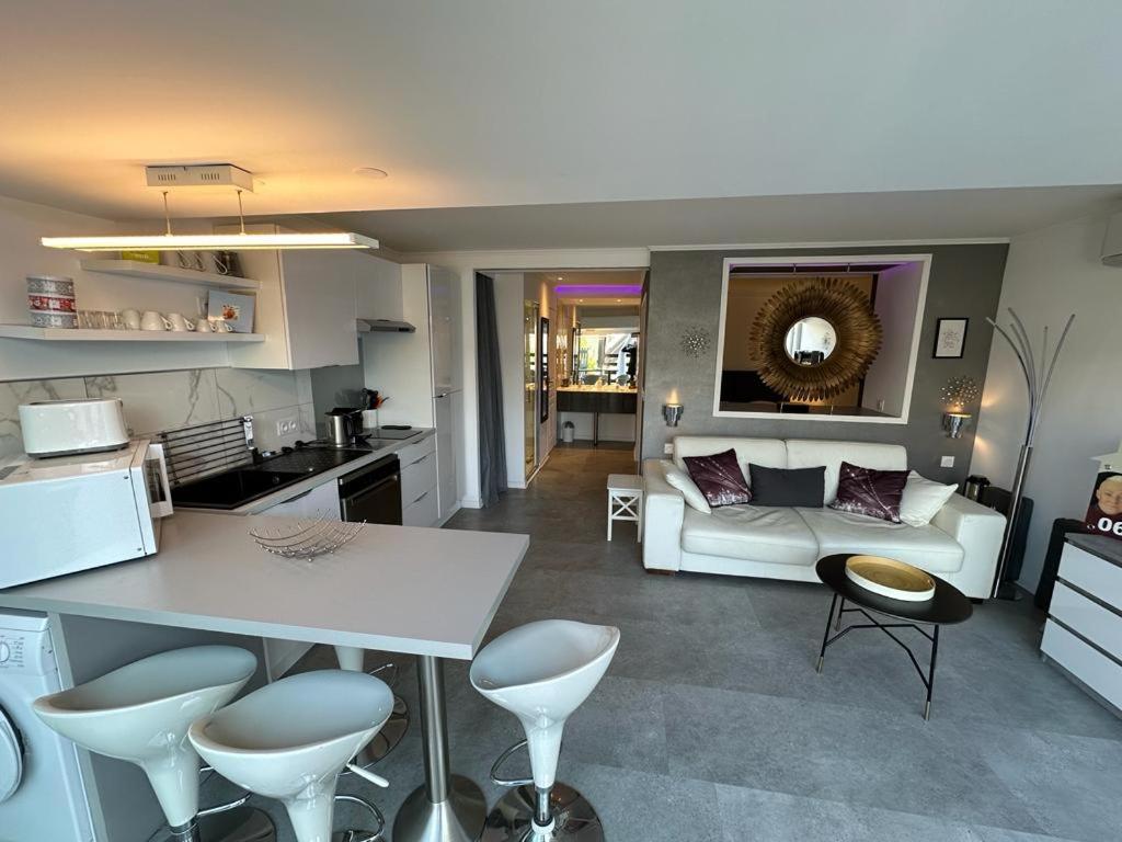 a kitchen and a living room with a white couch at villa naturiste standing Port Nature 2 Cap d'Agde in Cap d'Agde