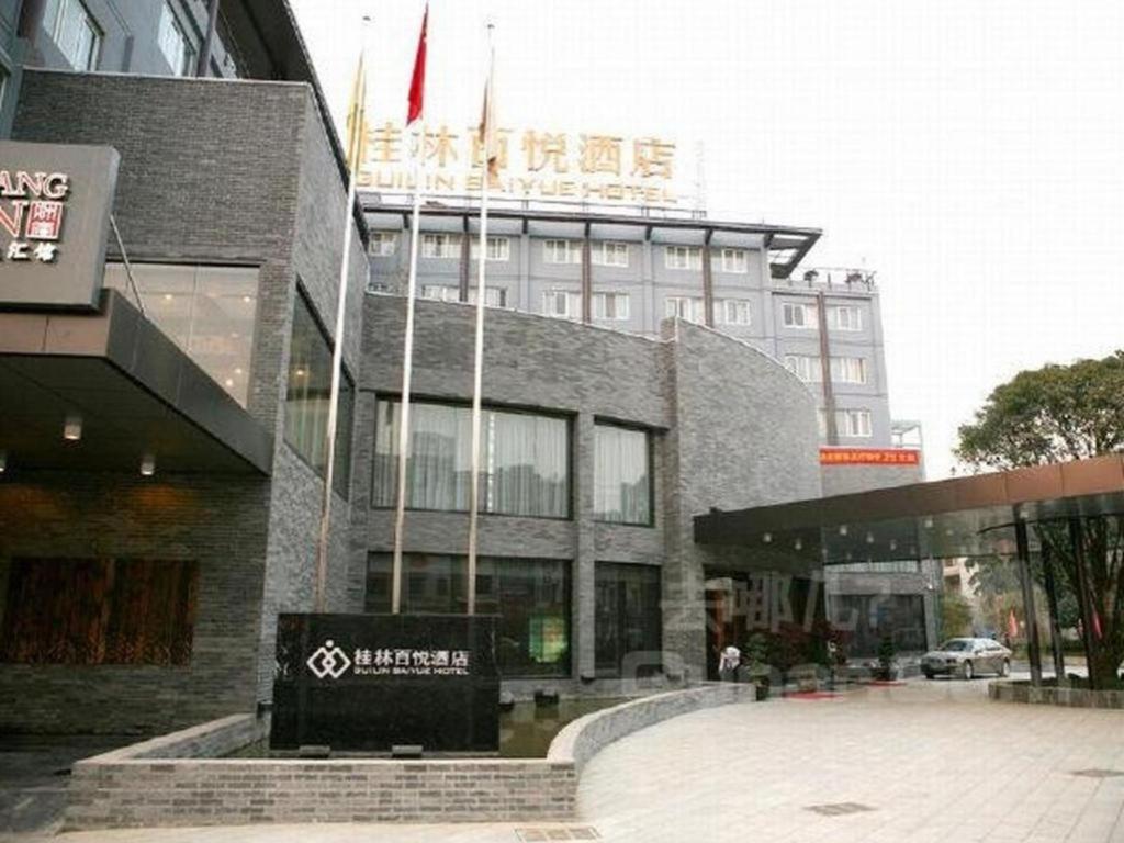 a building with a sign in front of it at Guilin Baiyue Hotel in Guilin