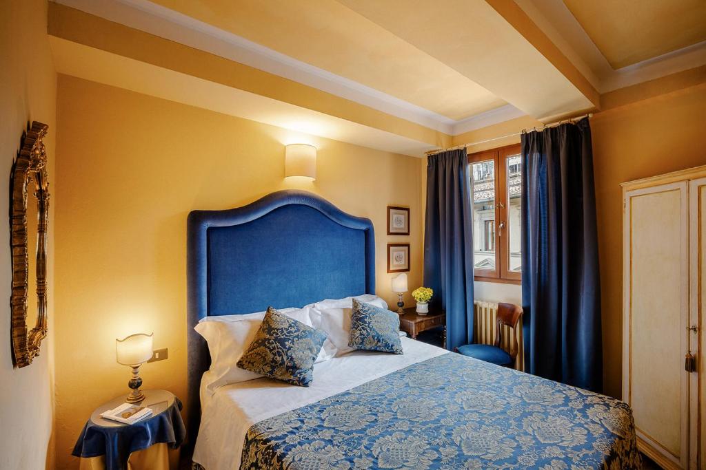 Postel nebo postele na pokoji v ubytování Hotel Palazzo dal Borgo