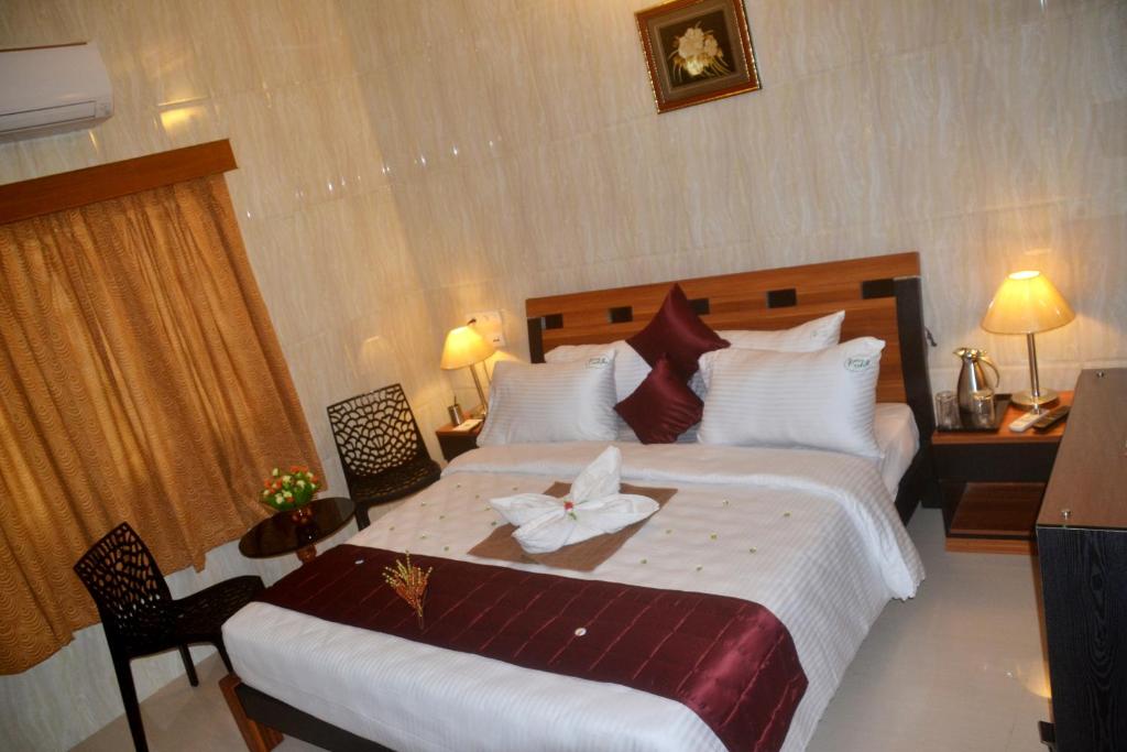 Postel nebo postele na pokoji v ubytování Peace Inn Chennai