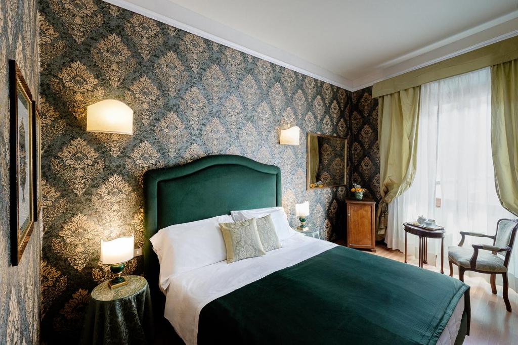 Postel nebo postele na pokoji v ubytování Hotel Palazzo dal Borgo