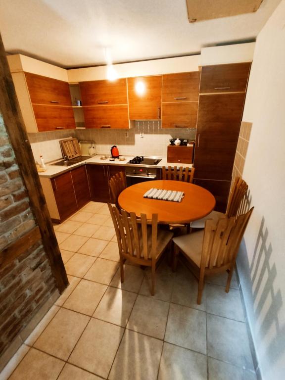 a small kitchen with a wooden table and chairs at Vila Dina in Sarajevo