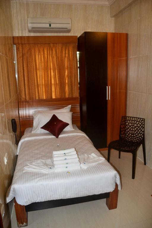 Postel nebo postele na pokoji v ubytování Peace Inn Chennai