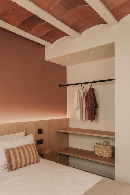 Postel nebo postele na pokoji v ubytování Pau Suites