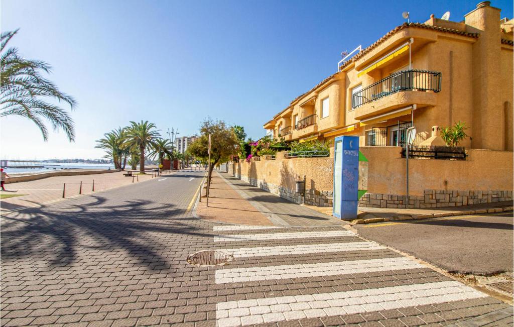 a street with a building on the side of a beach at Nice Home In San Javier With Wifi in San Javier