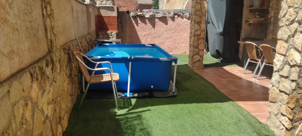 a blue cooler sitting on the grass next to a building at Cerro de la Garita in Concud