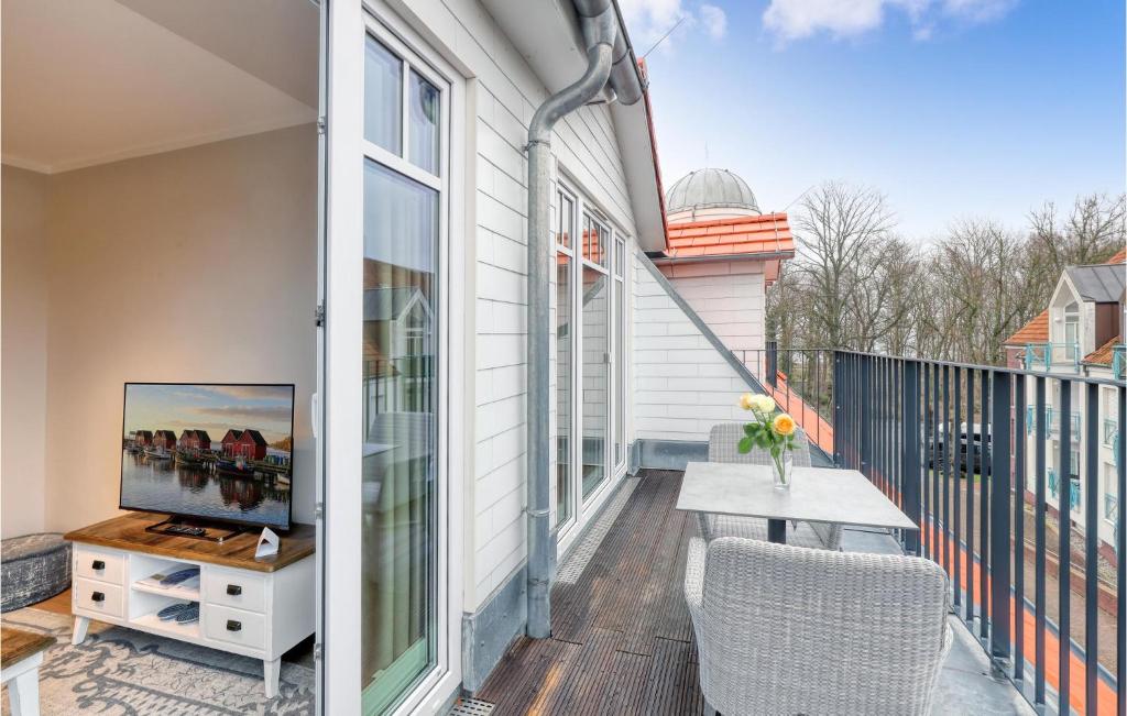 a balcony with a table and a television on it at Baltischer Hof Apartment 47 in Boltenhagen