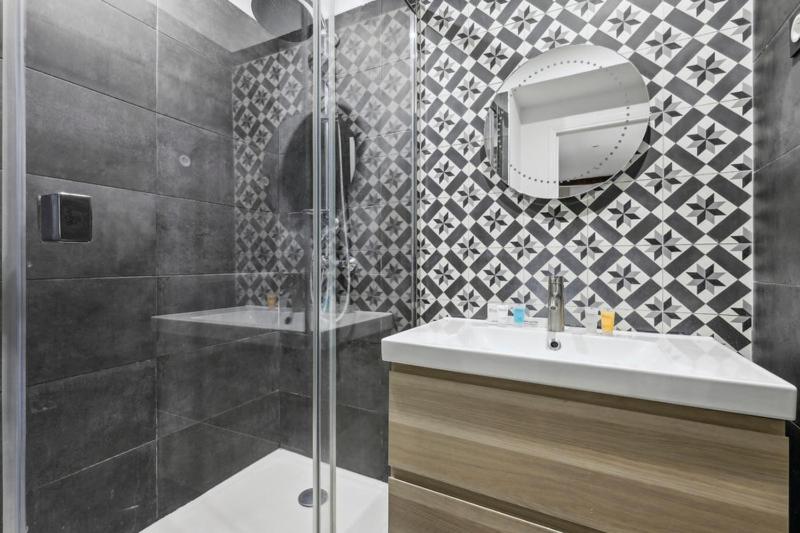 une salle de bain avec une douche, un lavabo et un miroir dans l'établissement 375 Suite Brady - Superbe Appartement à Paris, à Paris