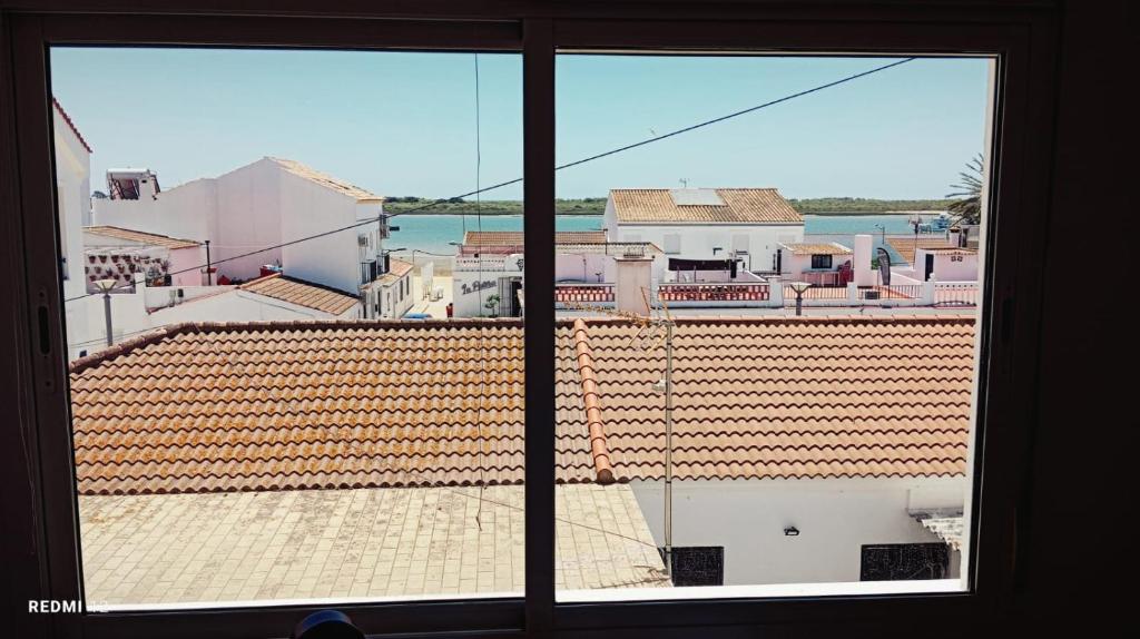 a view of a city from a window at CASA DE MARINEROS en LA RIA DEL ROMPIDO in Cartaya