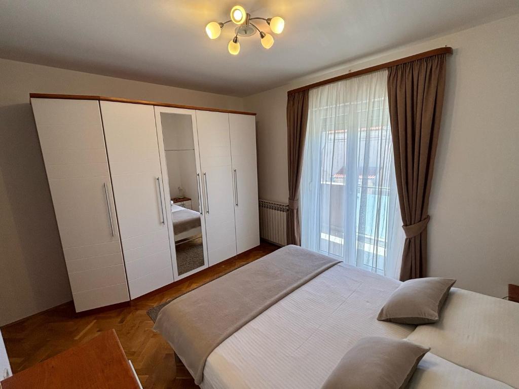 Łóżko lub łóżka w pokoju w obiekcie Kristina Apartments