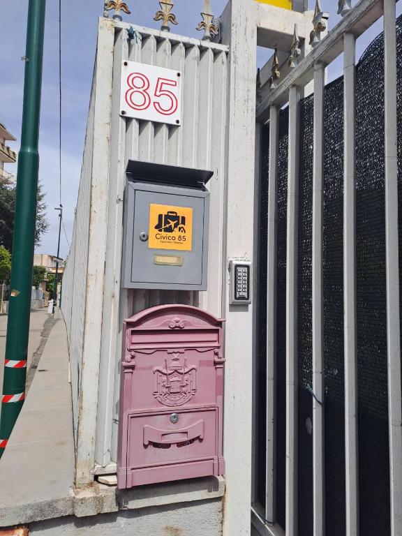 a pink door on the side of a building at Civico85 in Naples