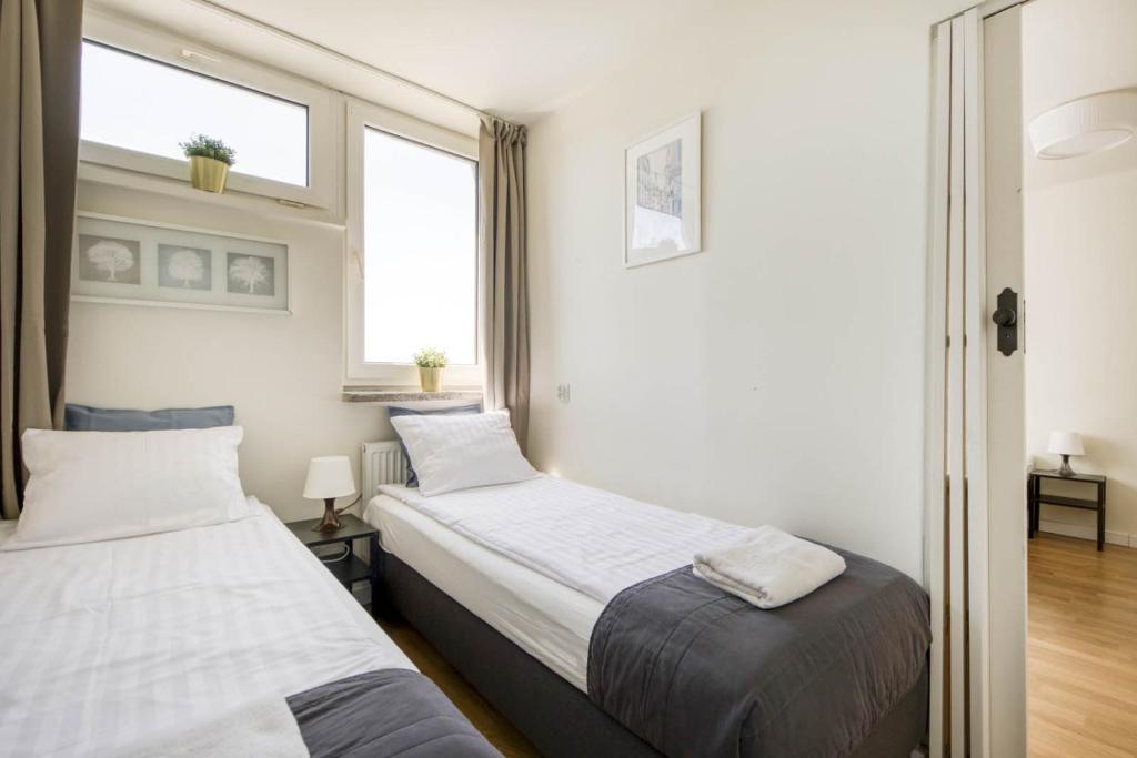 Posteľ alebo postele v izbe v ubytovaní Labo Apartment Żelazna Brama