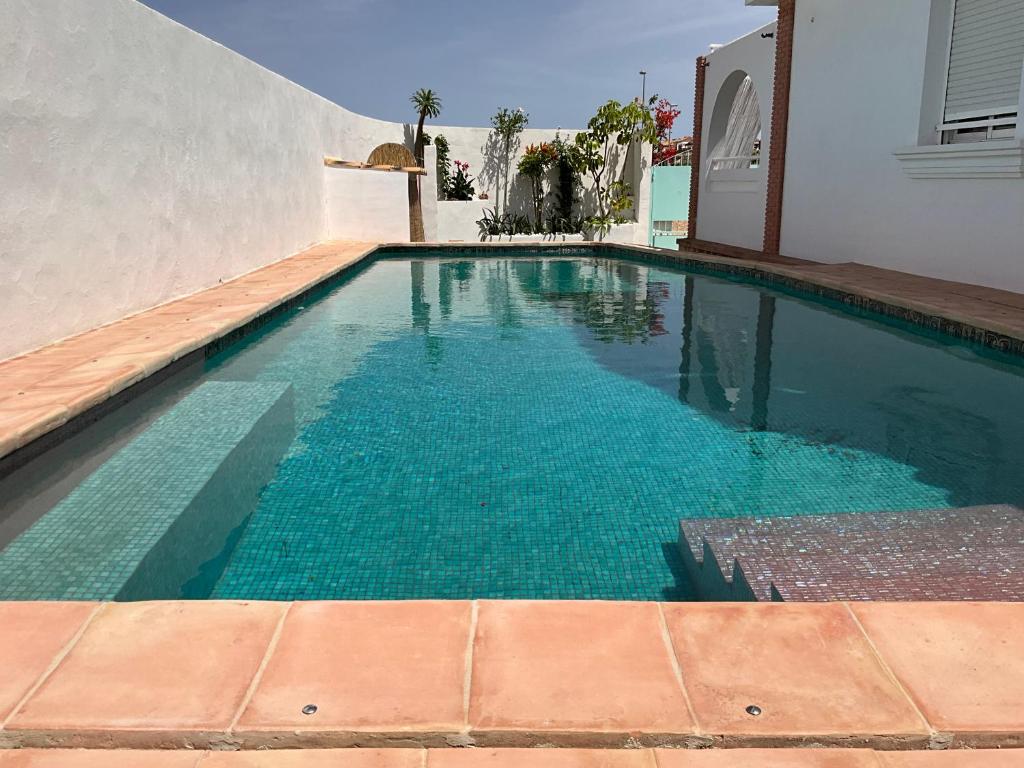 a swimming pool with blue water in a house at Fantastic Spanish villa with swimming pool in Sierra Golf, near Corvera airport in Murcia in La Tercia