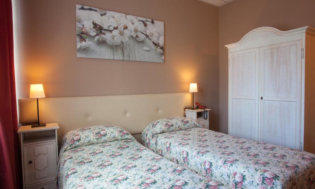 A bed or beds in a room at Ankon Hotel