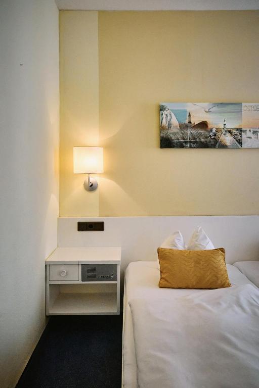 Postel nebo postele na pokoji v ubytování Herdegen Rooms - Self Check-in