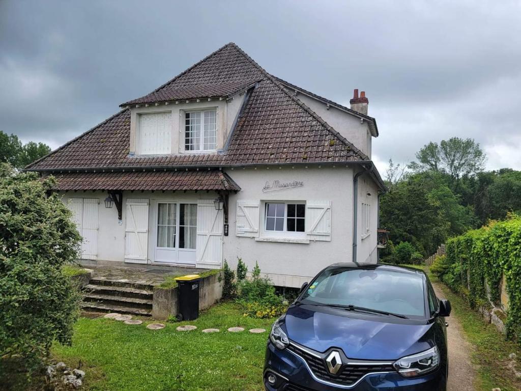 une voiture garée devant une maison blanche dans l'établissement Maison de vacances, à Seur