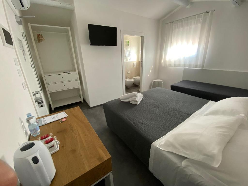 a hotel room with a bed and a table at Boutique Hotel Nuovo Cason in Cavallino-Treporti