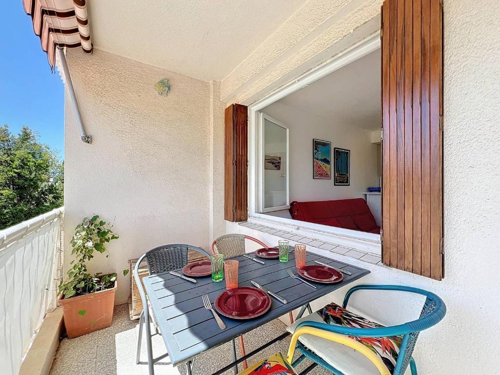 une table bleue et des chaises sur un balcon dans l'établissement T1 cosy avec terrasse et parking privé près de la plage des Lecques - FR-1-770-7, à Saint-Cyr-sur-Mer