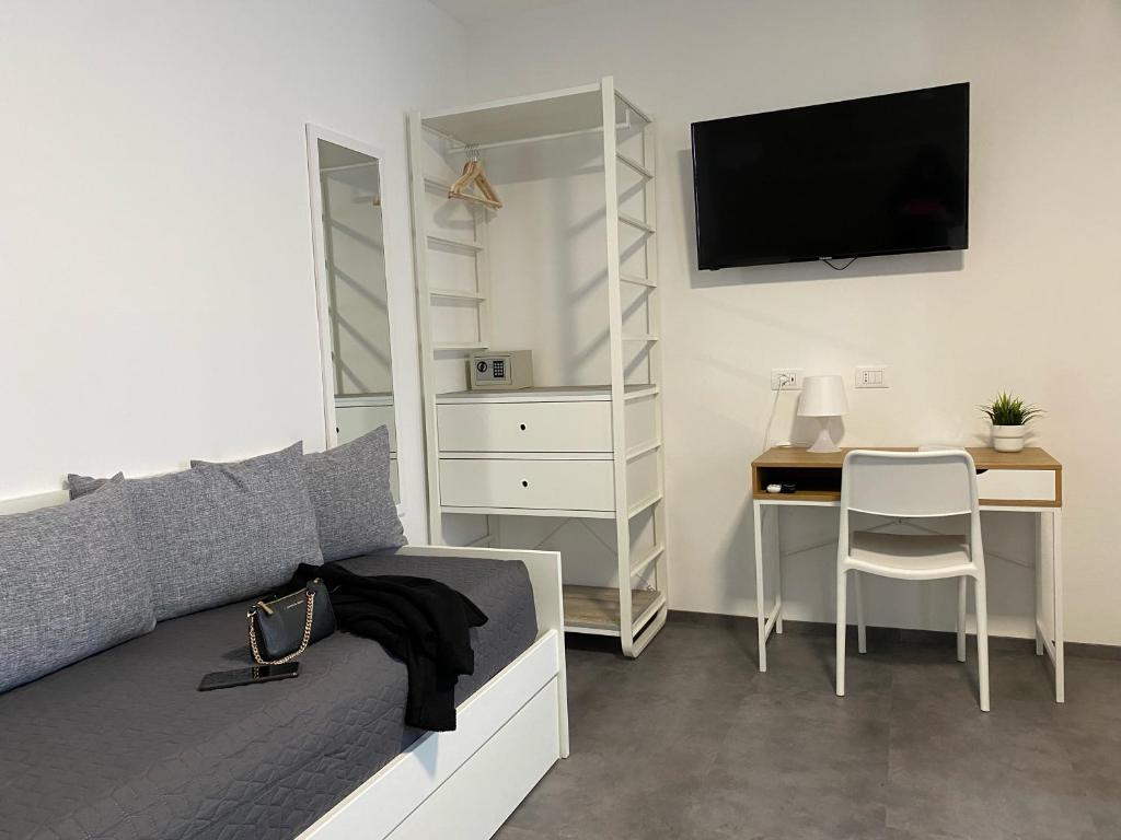 a bedroom with a bed and a desk with a television at Boutique Hotel Nuovo Cason in Cavallino-Treporti