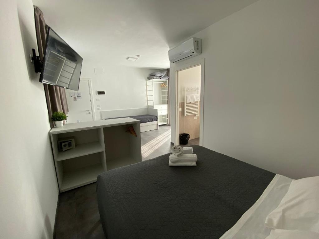 a bedroom with a bed and a television in it at Boutique Hotel Nuovo Cason in Cavallino-Treporti