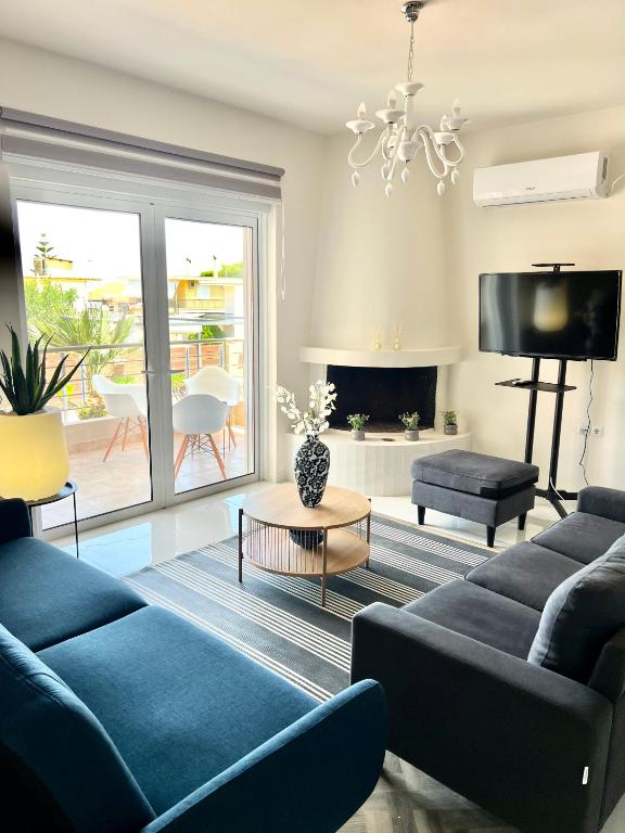 a living room with a blue couch and a fireplace at La Terra Luxury apartment in Kiveri