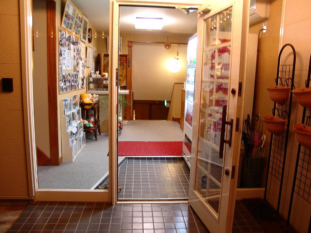 Postel nebo postele na pokoji v ubytování ペンション桜家
