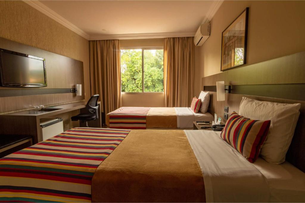 Postel nebo postele na pokoji v ubytování Hotel Deville Express Cascavel