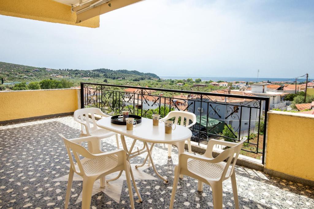 a white table and chairs on a balcony at PANORAMA in Potos