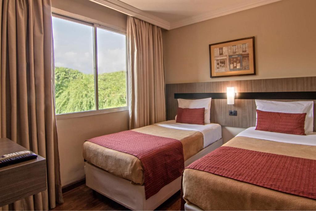 Postel nebo postele na pokoji v ubytování Hotel Deville Express Cascavel