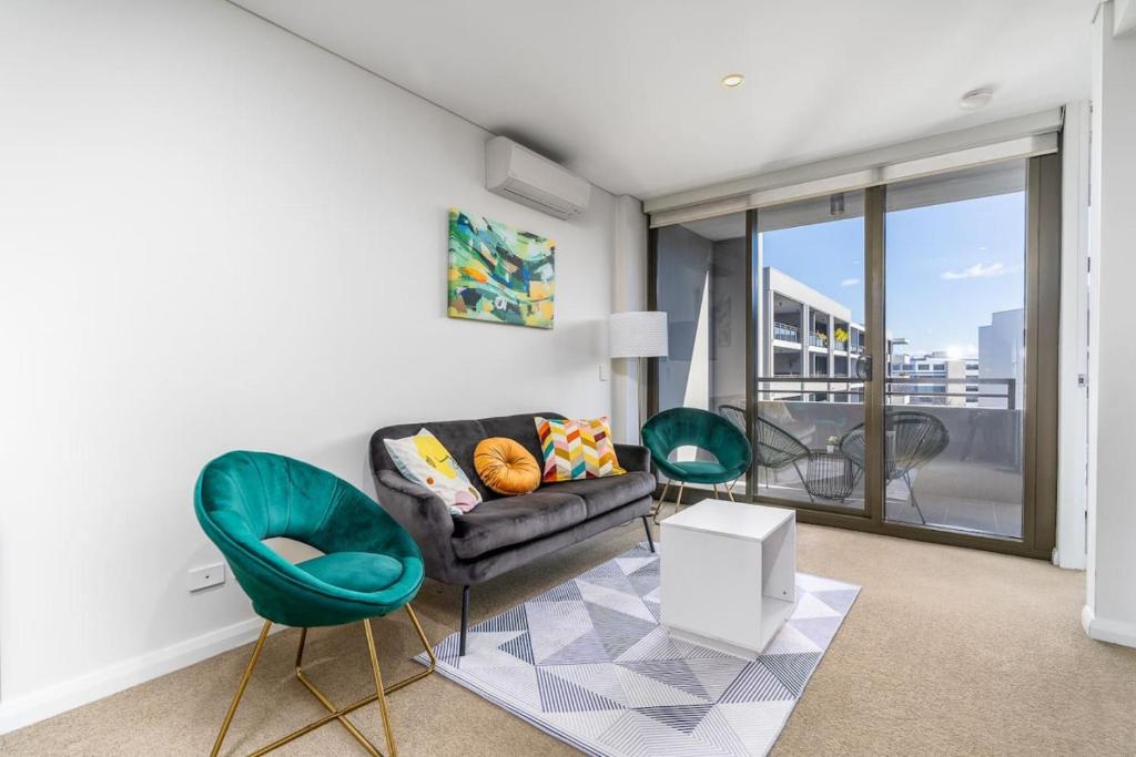 a living room with a couch and two chairs at Parliamentary Triangle 1BR Apartment - Hosted by CanStay in Canberra