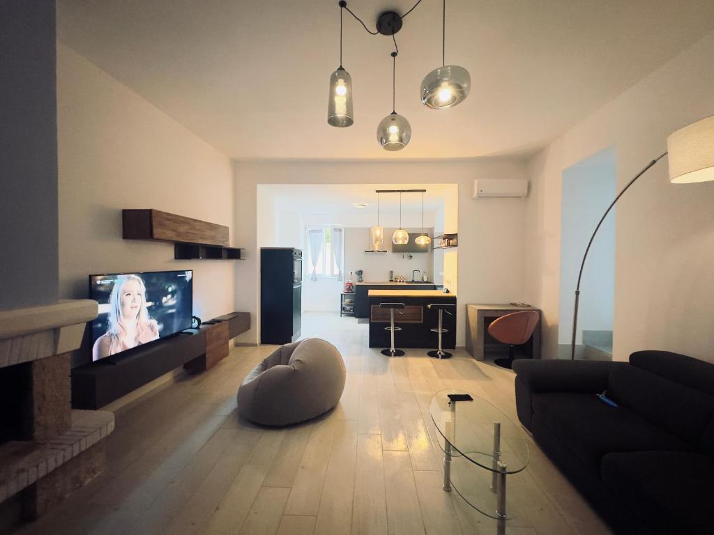 a living room with a couch and a flat screen tv at Casa Vacanze Aurelia in Procida
